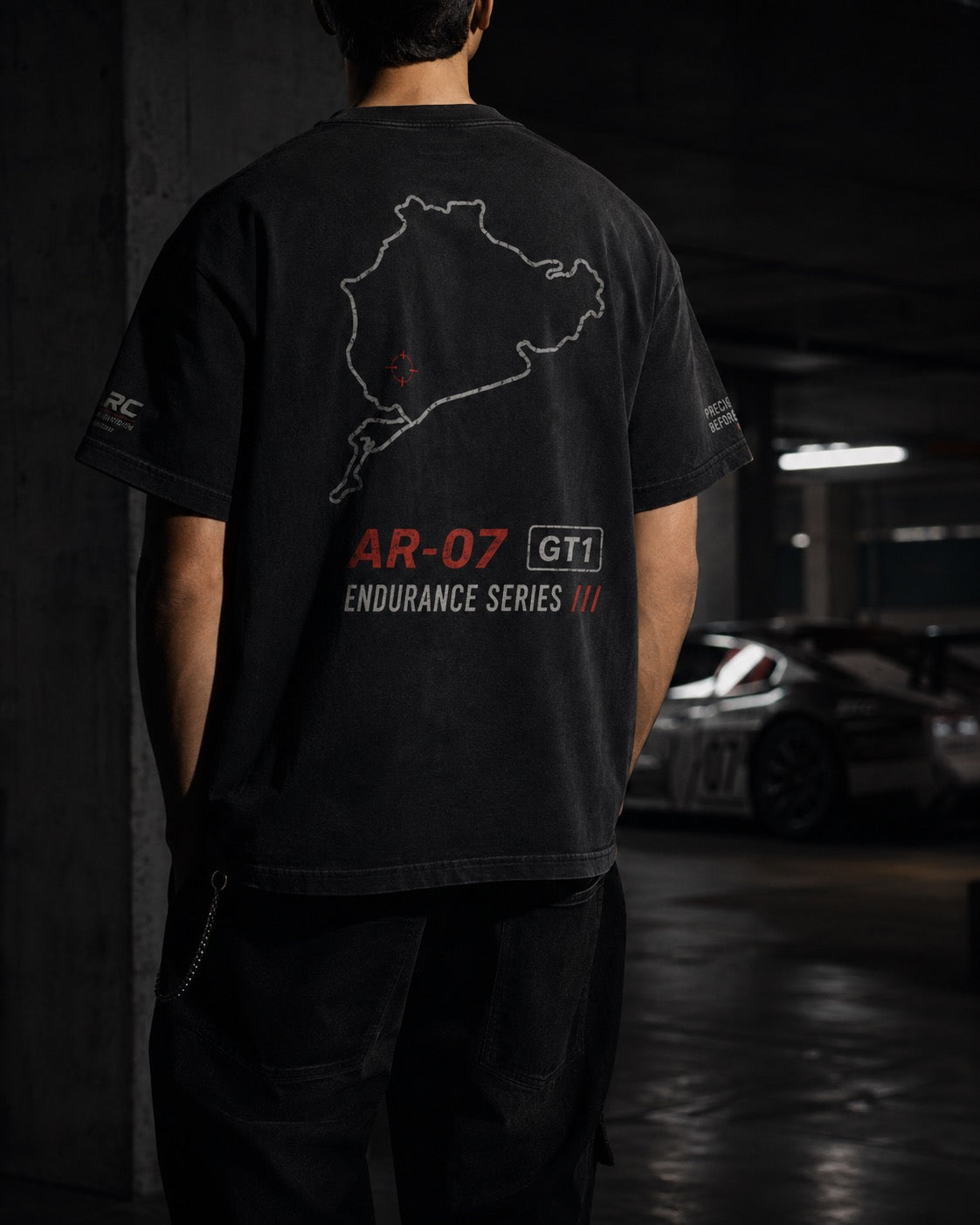 AR-07 Tee in Classic Black — patch detail